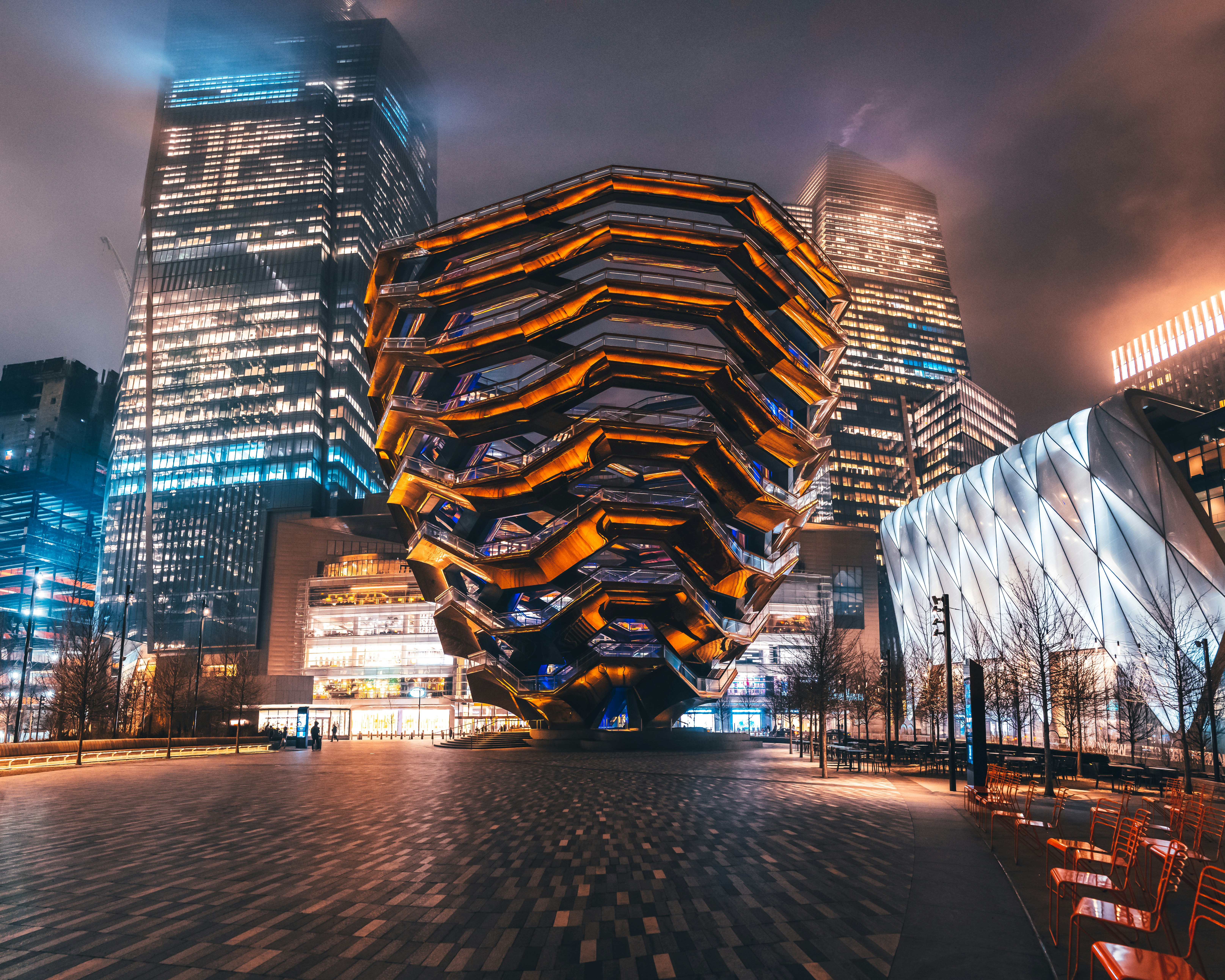 lighted building near body of water during night time